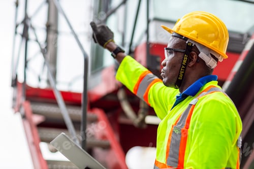 Preview: African Black Worker in Cargo Port Shipping Industrial in Yellow Hard Hat Safety Vest on Duty.