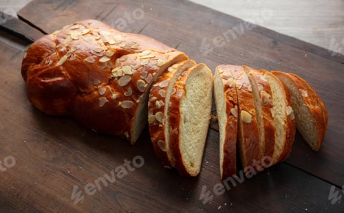 Preview: Easter sweet bread, homemade tsoureki braid on wooden table, closeup