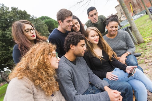 Preview: Multiethnic Group of Friends Looking at Mobile Phone