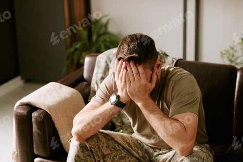 Preview: Caucasian Young Adult Man in Military Uniform Experiencing Emotional Distress