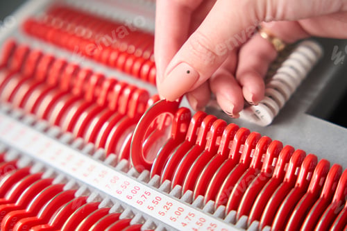 Preview: Specialist takes out a numbered lens from the organizer