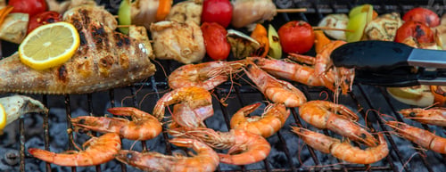 Preview: Shrimp, vegetables and fish are fried on a barbecue. Selective focus.