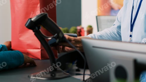 Preview: Woman paying for stylish clothes