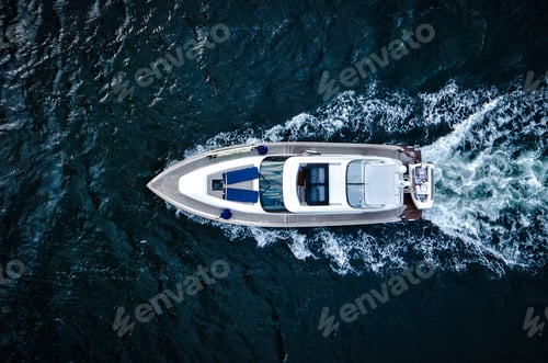 Preview: Top view of a motorized boat sailing through water leaving a foamy trail