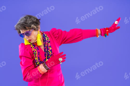 Preview: Happy and funny senior old woman on colorful background