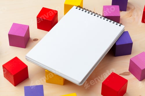 Preview: Notepad on wooden table and wood alphabet blocks