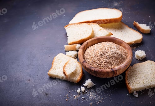Preview: Bowl of breadcrumbs and slices of a loaf