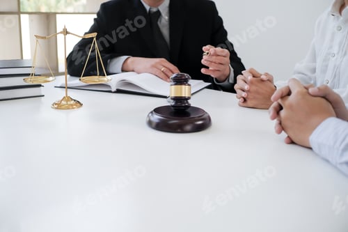 Preview: Legal counsel presents to the client a signed contract with gavel and legal law.
