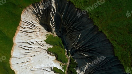 Preview: Contrasting green vegetation and white stony mountain peak. Clip. Aerial top view of stunning nature