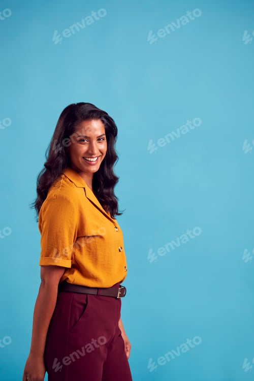 Preview: Portrait Of Mature Female Model Posing For Photographer Against Background On Studio Fashion Shoot