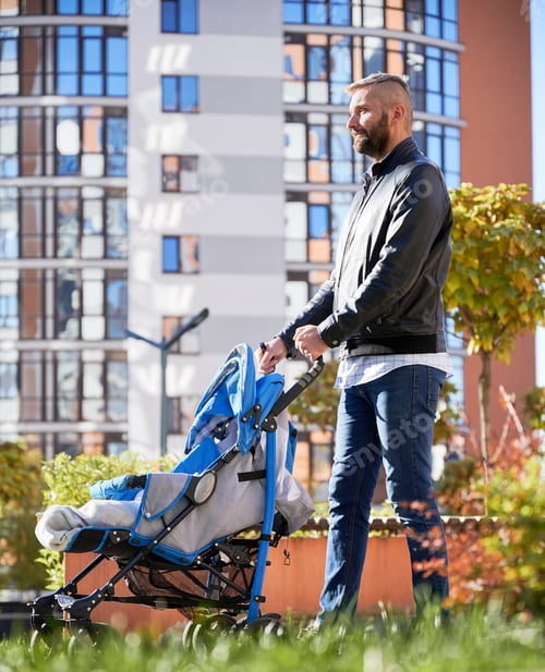 Preview: Father spending time with newborn kid outdoors.