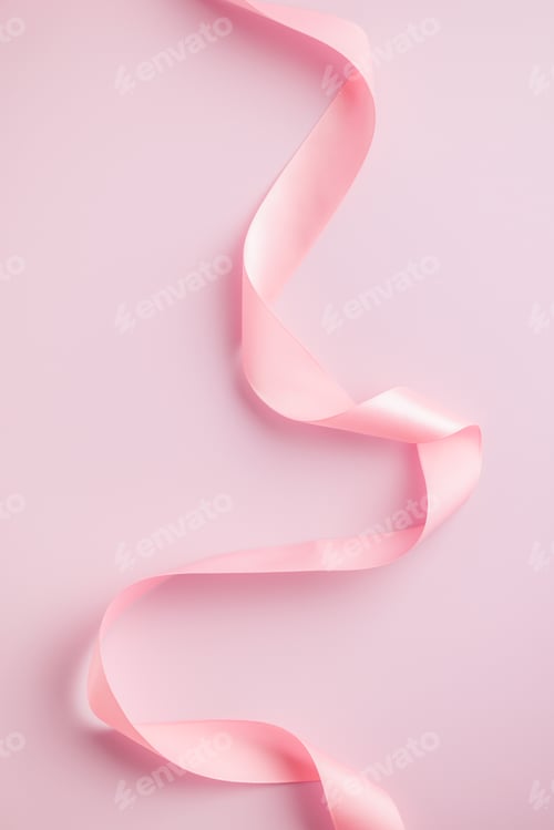 Preview: Curled pink ribbon on pink background.