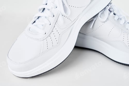 Preview: Pair of white male sneakers on white background isolated. Fashion stylish sport shoes, close up