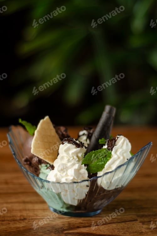 Preview: chocolate and mint ice cream sundae dessert on wooden table