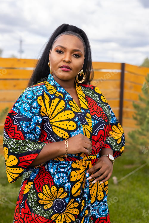 Preview: Summer portrait of beautiful african american woman in colourful dress wear standing on backyard