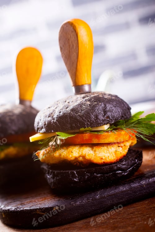 Preview: Tasty craft burger with black bun on the board