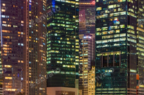 Preview: Pattern of office buildings windows illuminated at night. Lighting with Glass architecture facade