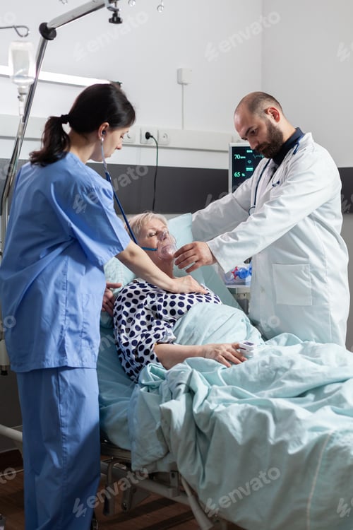 Preview: Doctor holding oxygen mask for senior woman patient helping her breath