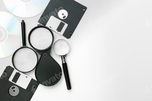 Preview: magnifying glass inspecting on floppy disk concept