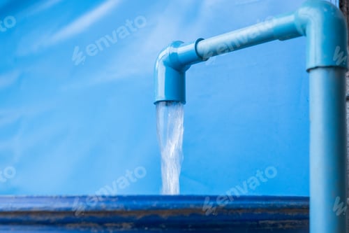 Preview: Blue pvc pipe with flowing water in bucket