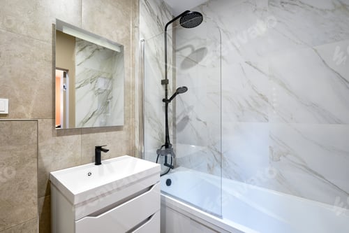 Preview: Modern bathroom featuring marble walls and sleek fixtures with a shower and bathtub combination