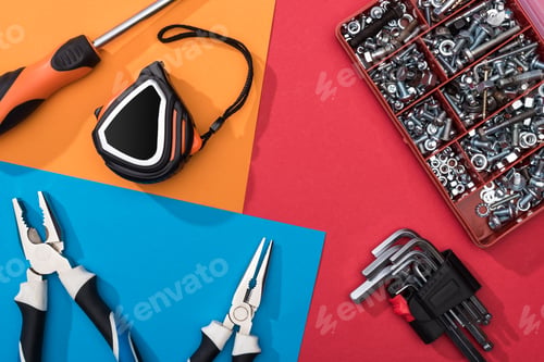 Preview: Top view of tool set with pliers and measuring tape on colorful background