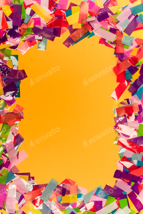 Preview: top view of colorful bright confetti frame on orange background