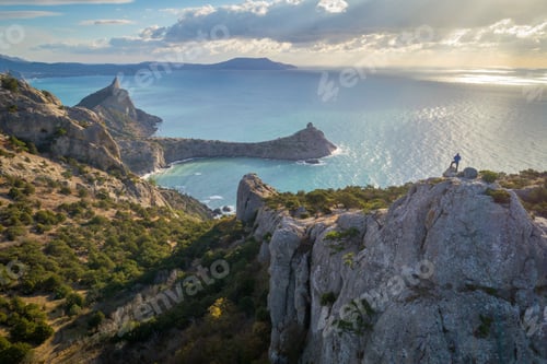 Preview: Man silhouette standing on a peak