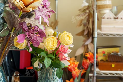 Preview: Vibrant Assortment of Artificial Flowers in a Vase Inside a Cozy Craft Room