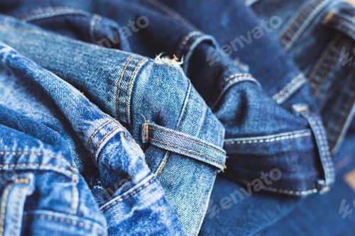 Preview: Jeans scattered on a wooden background