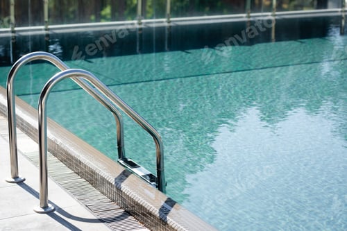 Preview: transparent swimming pool with railings on resort during daytime