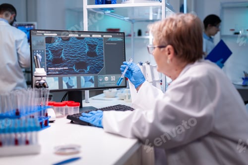 Preview: Biotechnologist senior scientist researching with test tube in pharma lab