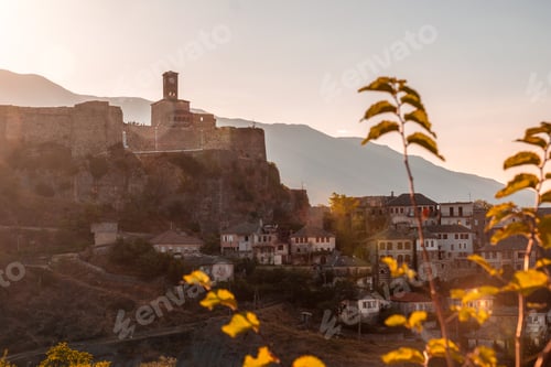 Preview: Sunset over the clock tower and Gjirokaster fortress, panoramic view of the city, Albania