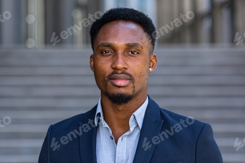 Preview: Portrait young confident successful African American businessman looking at camera