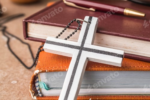 Preview: Cross against an old book