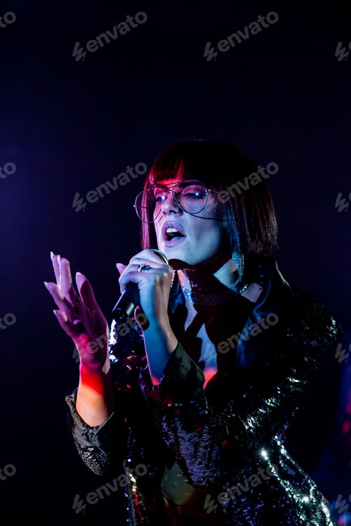 Preview: Stylish woman singing on stage