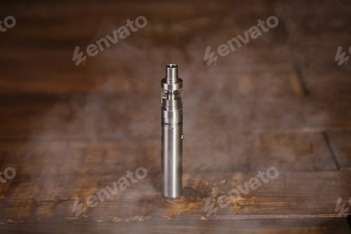 Preview: Electronic cigarette on a wooden table. Smoke