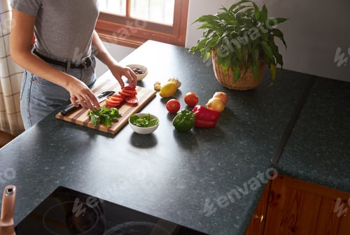 Preview: Woman preparing vegetarian dinner in a kitchen