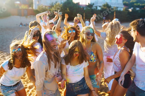 Preview: group of friends have fun, dance at holi festival. Celebrating traditional indian holiday.
