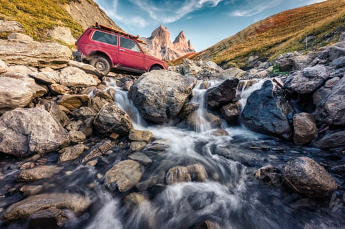Preview: Aiguilles d'Arves with iconic mountain peak and vintage car crossing the waterfall in the valley