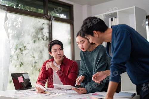 Preview: A creative team collaborates on user interface ideas and design concepts in a modern workspace.