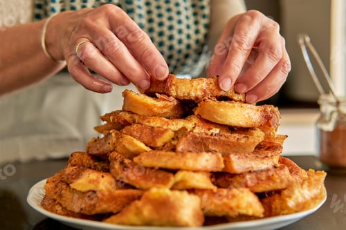 Preview: Close up of senior woman hands stacking easter and lent dessert.