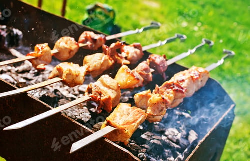 Grilled Meat Cooking over Charcoal Outdoors