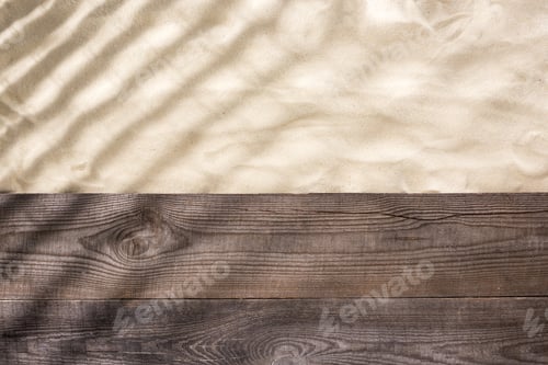 Preview: top view of sand and wooden brown board with shadows and copy space