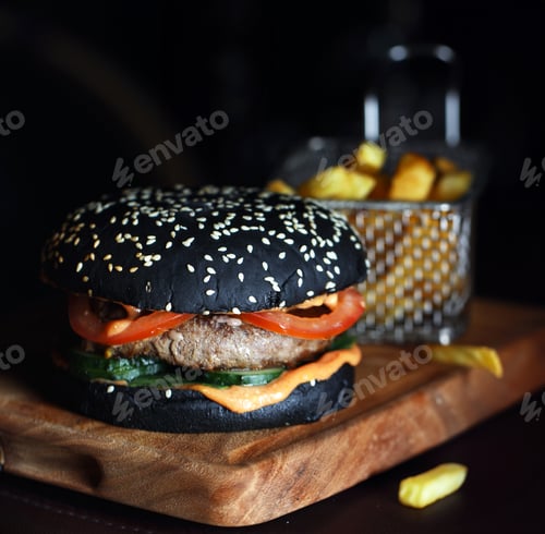 Preview: black burger with tomatoes and french fries