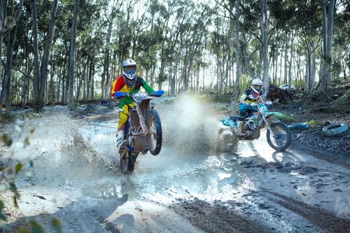 Preview: Two young male motocross riders racing on dusty track