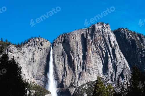 Preview: Low-angle view of Yosemite falls under the blue sky on a sunny day