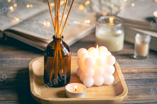 Preview: Winter spa composition with incense sticks, candles and bokeh lights.