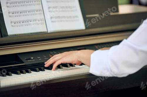 Preview: Woman plays electric piano at outdoor music performance, close up view to nimble hands