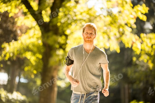 Preview: Young man running in the autumn park
